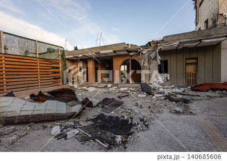 Bila Tserkva, Kyiv region, Ukraine - 09.06.2025: Wide angle view of damaged modern building complex with collapsed concrete roof shattered window shrapnel holes and metal debris after explosion Bila Tserkva, Kyiv region, Ukraine - 09.06.2025: Wide angle view of damaged modern building complex with collapsed concrete roof shattered window shrapnel holes and metal debris after explosion 140685606