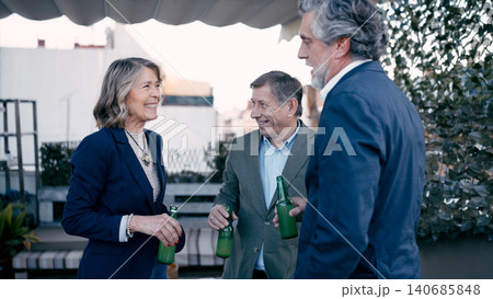 Seniors friends enjoying drinks at a rooftop party 140685848