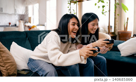 Friends enjoying fun video game competition at home 140685860