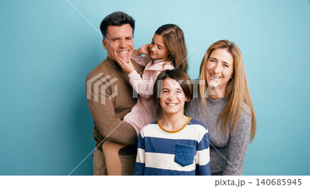 Happy family with parents and children smiling together Happy family with parents and children smiling together 140685945