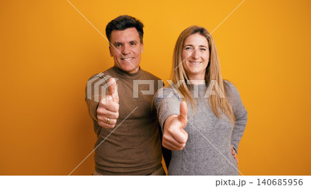 Happy couple giving thumbs up in agreement Happy couple giving thumbs up in agreement 140685956