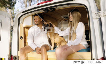 Couple and boxer dog enjoying van life adventure 140686073