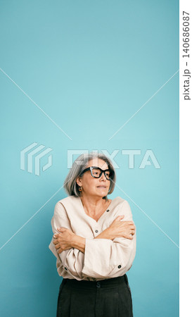 Senior woman feeling cold hugging herself with crossed arms 140686087