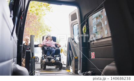 Man in wheelchair using accessible van lift 140686238