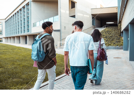 Diverse students walking on university campus together Diverse students walking on university campus together 140686282