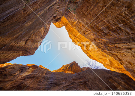 road through the Siq Gorge, canyon, the symbol of the city of Petra, at daytime, Wadi Musa, Jordan 140686358