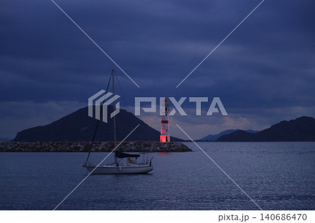 Seascape at sunshine. Lighthouse and sailings on the coast. Seaside town of Turgutreis and spectacular sunshine 140686470