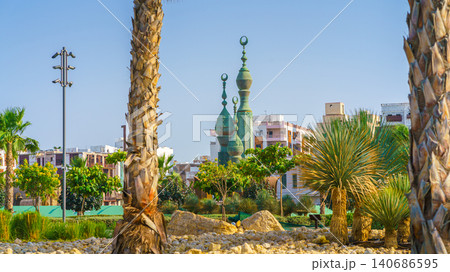 Jeddah, Saudi Arabia- Mar 08 2023, panoramic view Minaret tops at Douar Kharjiya Roundabout - Al Bayya Square, in the foreground are palm trees and various plants, at daytime, Jeddah, Saudi Arabia Jeddah, Saudi Arabia- Mar 08 2023, panoramic view Minaret tops at Douar Kharjiya Roundabout - Al Bayya Square, in the foreground are palm trees and various plants, at daytime, Jeddah, Saudi Arabia 140686595