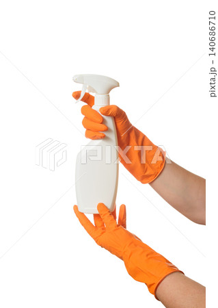 hands in orange gloves holding a white spray bottle on a white background hands in orange gloves holding a white spray bottle on a white background 140686710