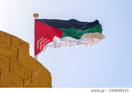 Aqaba, Jordan, a close up view, the flag of the Arab revolt are fluttering in the wind, at daytime Aqaba, Jordan, a close up view, the flag of the Arab revolt are fluttering in the wind, at daytime 140686933
