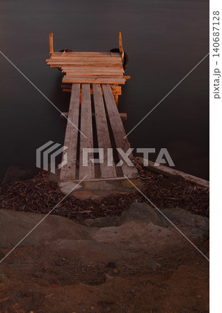 Old abandoned wooden fishing pier on the sea in the countryside 140687128