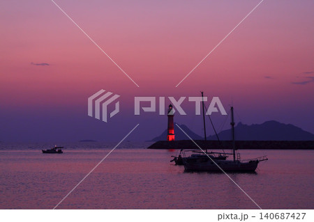 Seascape at sunshine. Lighthouse and sailings on the coast. Seaside town of Turgutreis and spectacular sunshine 140687427