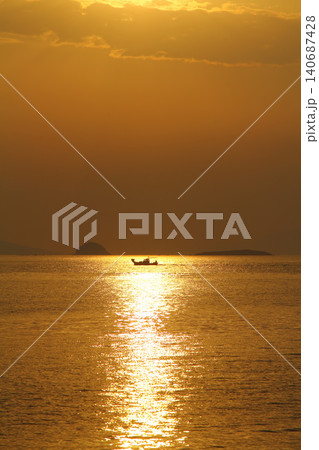 Alone sailboat at sunset. Atmospheric seascape with reflection Alone sailboat at sunset. Atmospheric seascape with reflection 140687428