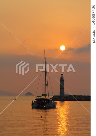 Seascape at sunshine. Lighthouse and sailings on the coast. Seaside town of Turgutreis and spectacular sunshine Seascape at sunshine. Lighthouse and sailings on the coast. Seaside town of Turgutreis and spectacular sunshine 140687436