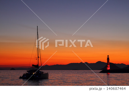 Seascape at sunshine. Lighthouse and sailings on the coast. Seaside town of Turgutreis and spectacular sunshine 140687464