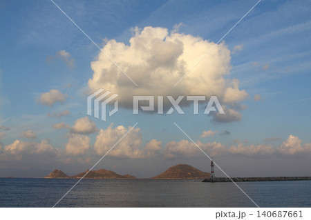 Seascape at sunshine. Lighthouse and sailings on the coast. Seaside town of Turgutreis and spectacular sunshine Seascape at sunshine. Lighthouse and sailings on the coast. Seaside town of Turgutreis and spectacular sunshine 140687661