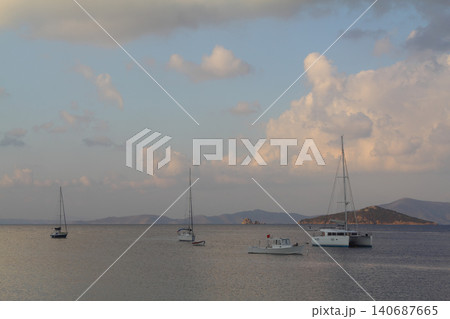 Seascape at sunshine. Lighthouse and sailings on the coast. Seaside town of Turgutreis and spectacular sunshine Seascape at sunshine. Lighthouse and sailings on the coast. Seaside town of Turgutreis and spectacular sunshine 140687665