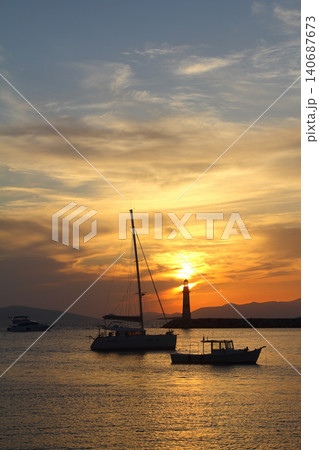 Seascape at sunshine. Lighthouse and sailings on the coast. Seaside town of Turgutreis and spectacular sunshine Seascape at sunshine. Lighthouse and sailings on the coast. Seaside town of Turgutreis and spectacular sunshine 140687673