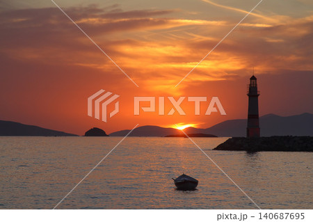 Seascape at sunshine. Lighthouse and sailings on the coast. Seaside town of Turgutreis and spectacular sunshine Seascape at sunshine. Lighthouse and sailings on the coast. Seaside town of Turgutreis and spectacular sunshine 140687695