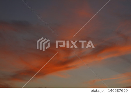 Dramatic red and orange sky and clouds abstract background. Red-orange clouds on sunset sky. Warm weather background. Art picture of sky at dusk Dramatic red and orange sky and clouds abstract background. Red-orange clouds on sunset sky. Warm weather background. Art picture of sky at dusk 140687699