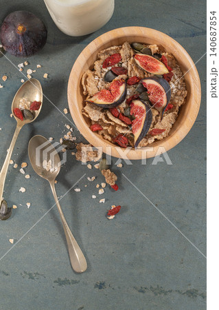 Granola for healthy breakfast. Bowl with granola , milk , fresh fig and dried berries 140687854