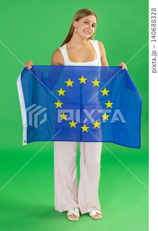 Teenage girl holding EU flag in front of green screen Teenage girl holding EU flag in front of green screen 140688328