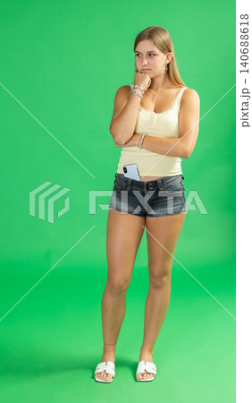 Sad thoughtful teenage girl in front of green screen 140688618