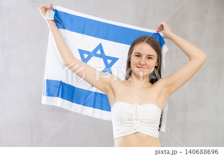 Girl holds unfolded canvas flag of Israel 140688696