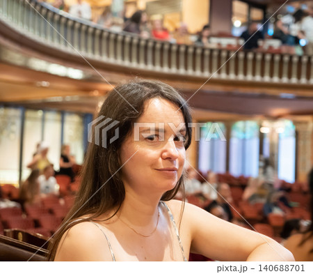 Portrait of a young woman in mezzanine theater 140688701