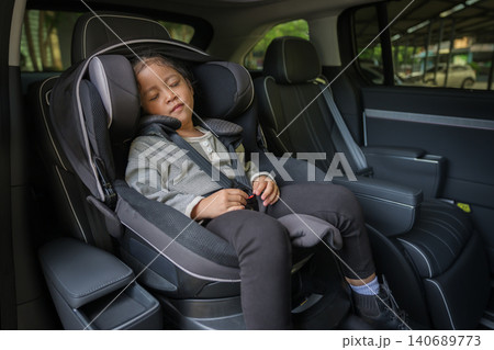 preschool child girl sitting and sleeping in car seat, safety baby chair travelling preschool child girl sitting and sleeping in car seat, safety baby chair travelling 140689773