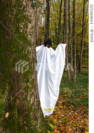 Ghost Costume with Glasses and Cap Standing in Autumn Forest Ghost Costume with Glasses and Cap Standing in Autumn Forest 140690320