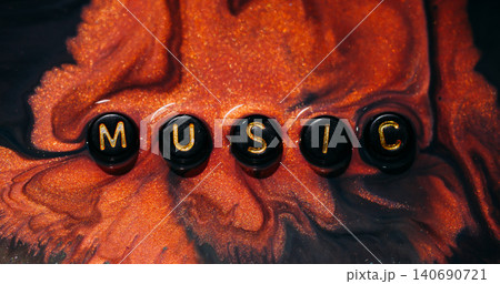 Music paint word. Color fluid spill. Defocused yellow purple orange glitter melody liquid black letters texture on abstract creative art background. Music paint word. Color fluid spill. Defocused yellow purple orange glitter melody liquid black letters texture on abstract creative art background. 140690721