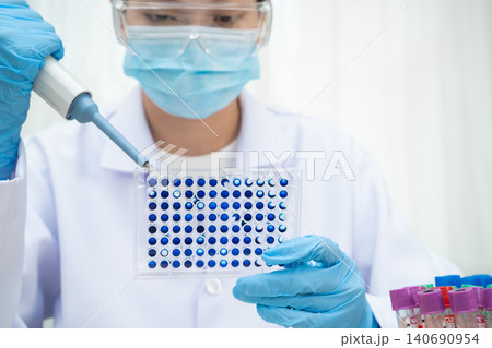 Scientist with cell culture in sample micro plate for research in science laboratory. Scientist with cell culture in sample micro plate for research in science laboratory. 140690954