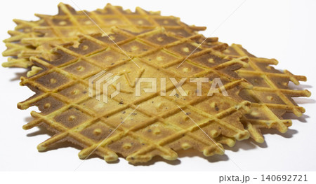 Group of pizzelles on white background. Spiced biscuits of Italian origin. Group of pizzelles on white background. Spiced biscuits of Italian origin. 140692721