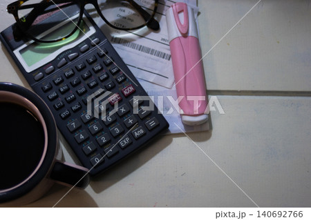 Desktop workspace showing a calculator, pen, and receipt, representing financial management, budgeting, and remote work, Desktop workspace showing a calculator, pen, and receipt, representing financial management, budgeting, and remote work, 140692766