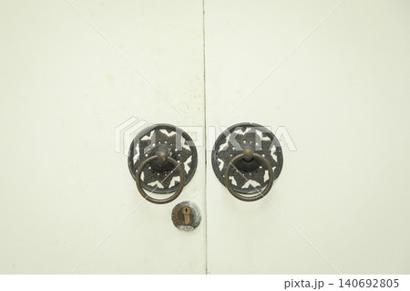 Two metal handles on a wooden door in Bali Two metal handles on a wooden door in Bali 140692805