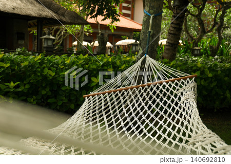 A hammock sways gently among trees and plants in Bali 140692810