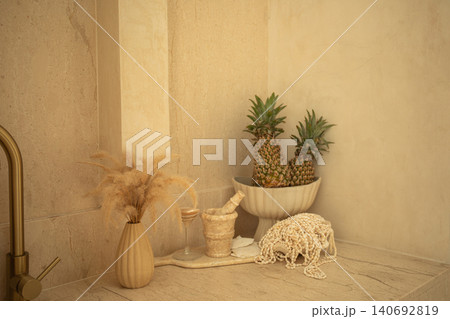 Stylish kitchen corner featuring pineapples and decorative elements 140692819