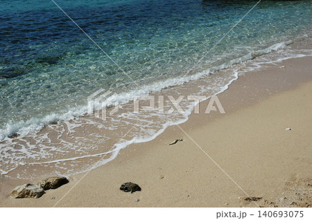 Clear turquoise sea water and sandy beach shoreline Clear turquoise sea water and sandy beach shoreline 140693075