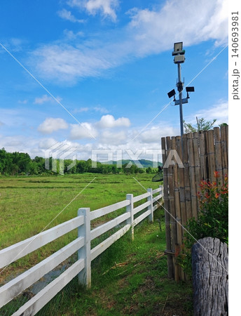 CCTV cameras installed on the wall for security monitoring, With a backdrop of beautiful meadows and mountains, under a clear sky. CCTV cameras installed on the wall for security monitoring, With a backdrop of beautiful meadows and mountains, under a clear sky. 140693981