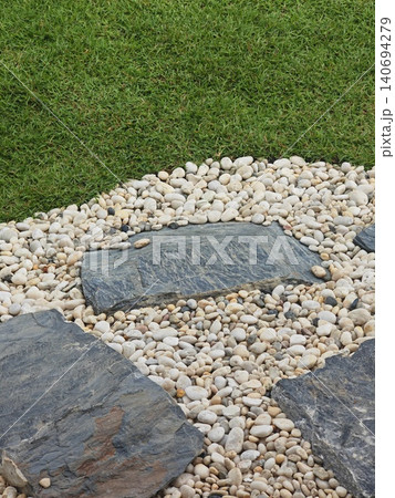 A lawn path decorated with stones. A lawn path decorated with stones. 140694279