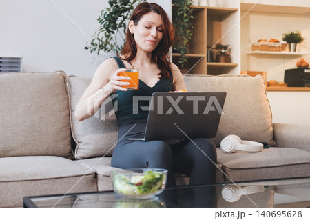 Woman preparing green smoothie in bright kitchen with fresh fruits and vegetables, healthy eating lifestyle moment in natural daylight Woman preparing green smoothie in bright kitchen with fresh fruits and vegetables, healthy eating lifestyle moment in natural daylight 140695628