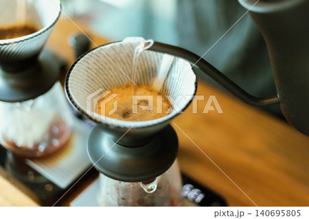 Barista making drip coffee. Barista making drip coffee. 140695805
