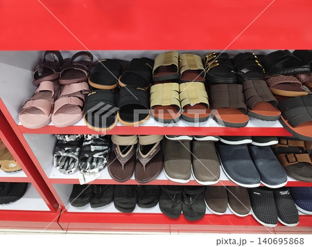 Women's shoes and sandals neatly arranged on shelves, photo taken in a supermarket Women's shoes and sandals neatly arranged on shelves, photo taken in a supermarket 140695868