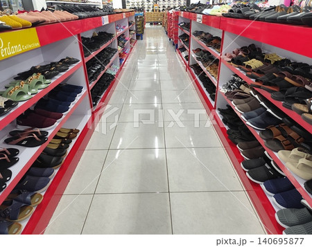 Women's shoes and sandals neatly arranged on shelves, photo taken in a supermarket 140695877