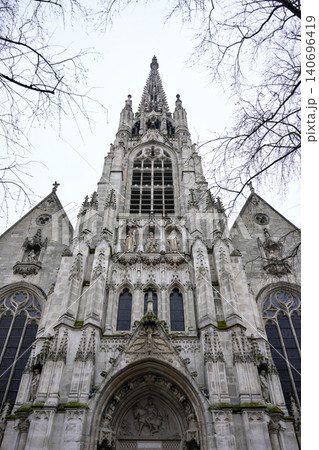 Gothic Church Facade With Ornate Portal and Spire in Lille France Gothic Church Facade With Ornate Portal and Spire in Lille France 140696419