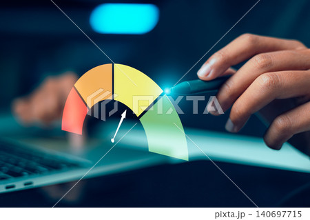 businessman hand holding stylus pen pointing at a colorful virtual rating gauge meter on laptop, representing credit score assessment, risk management, or performance KPI audit. 140697715