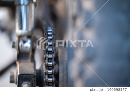 Close up of motorbike chain. Dirty motorbike chain on rear wheel Close up of motorbike chain. Dirty motorbike chain on rear wheel 140698377