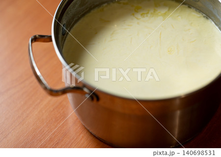 Homemade yogurt in a pan. Making cream yogurt for treating stomach Homemade yogurt in a pan. Making cream yogurt for treating stomach 140698531