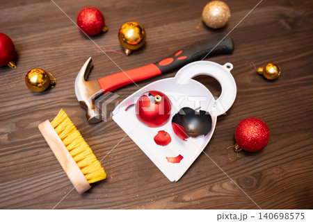 Red broken Christmas ball made of glass on the white scoop on the floor. Mess in the room during Christmas time, accident while decoration the Christmas tree, lack of festive mood concept 140698575